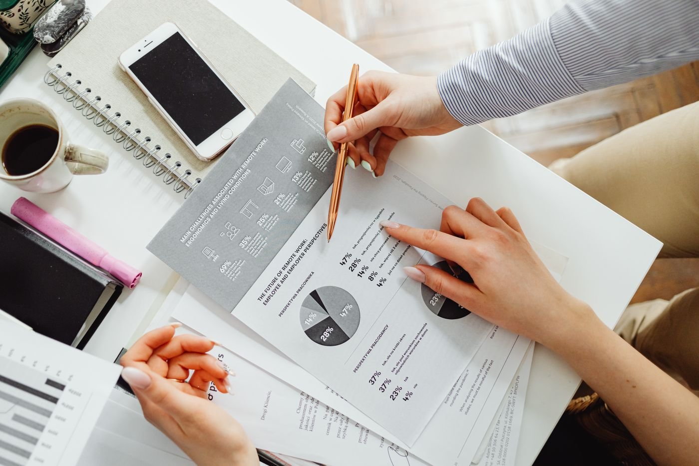 Marketing analyst reviewing local search ranking data and analytics charts at a desk