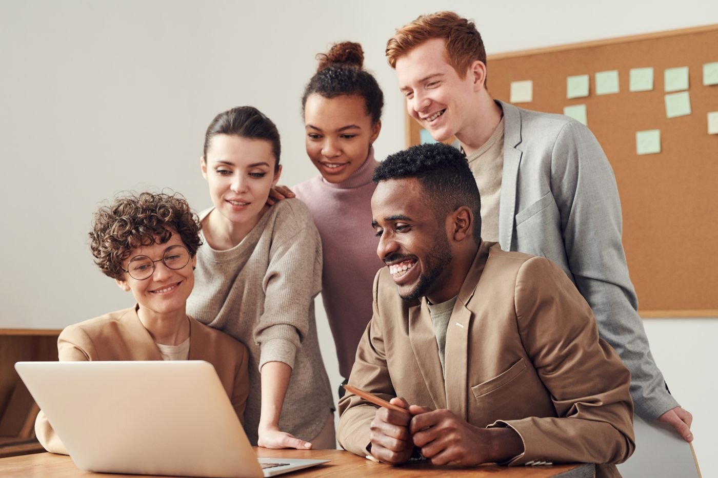 Web design team reviewing a website mockup on a laptop together