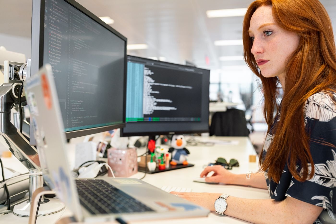 Web developer building a responsive website on a dual-monitor setup